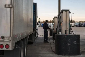 Diesel fuel island at a US truck stop with semi trucks in late afternoon